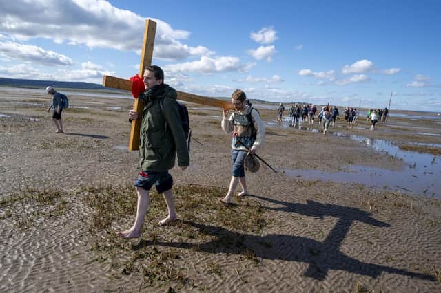 Pilgrims carrying wooden crosses to the Holy Island of Lindisfarne in Northumberland on Good Friday. ​The church needs to get out there and mix it. Photo: Jane Barlow/PA Wire