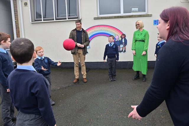 Principal Gemma Harrison , Parents Jamie Maguire and Joyce Holmes and pupils Toby and Joel Maguire and Daniel , Adam and Mathew Shields in the playground
