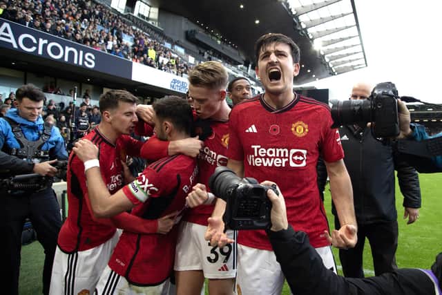 Manchester United's Bruno Fernandes (second left) celebrates with team-mates after scoring the winning goal against Fulham at Craven Cottage. (Photo by Kieran Cleeves/PA Wire)
