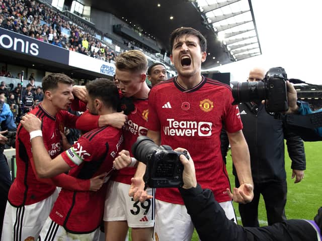 Manchester United's Bruno Fernandes (second left) celebrates with team-mates after scoring the winning goal against Fulham at Craven Cottage. (Photo by Kieran Cleeves/PA Wire)