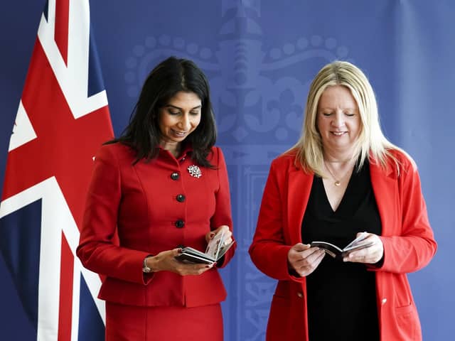 Home Secretary Suella Braverman and Abi Tierney, Director General of HM Passport Office and UK Visas and Immigration with the new King Charles III UK passport, at the Home Office, central London