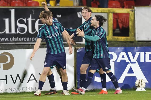 Cliftonville’s Alex Bannon celebrates with his team-mates after opening the scoring at Shamrock Park. (Photo by Brian Little/INPHO)
