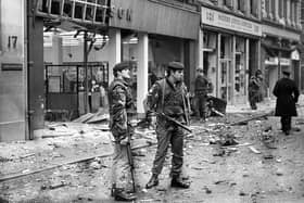 British soldiers survey damage in the aftermath of an IRA car bomb in Belfast on April 14, 1972 (photo by Alex Bowie/Getty Images)
