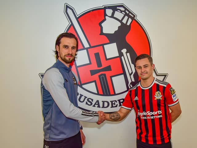 Declan Caddell welcomes Jordan Stewart to Crusaders. PIC: Crusaders FC