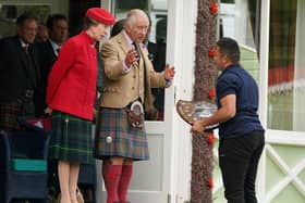 A competitor receives a plaque from the Princess Royal and King Charles III during the Braemar Gathering highland games held a short distance from the royals' summer retreat at the Balmoral estate in Aberdeenshire. Picture date: : Andrew Milligan/PA Wire