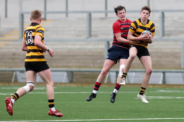 Ballymena’s Michael  McLean challenges RBAI’s James Kerr in the Schools' Cup final at Kingspan Stadium