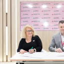 Michele Tarnow, founder, CEO, Alliance Care Technologies with founder, CEO of Belfast's Sonrai Analytics, Dr Darragh McArt signing the partnership agreement at Arab Health in Dubai