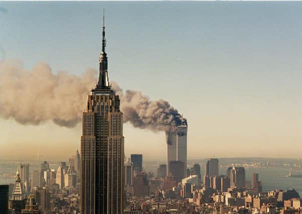 The twin towers of the World Trade Centre in New York burn behind the Empire State Building on September 11, 2001. The US unleashed its War on Terror,  but if the UK had used the same tactics, Dundalk would have been flattened  (AP Photo/Marty Lederhandler/FILE)