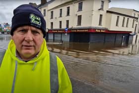 Brendan Downey, director of Friar Tucks restaurants, surveys the damage to one of his businesses - just behind him - caused by severe flooding in Newry.
