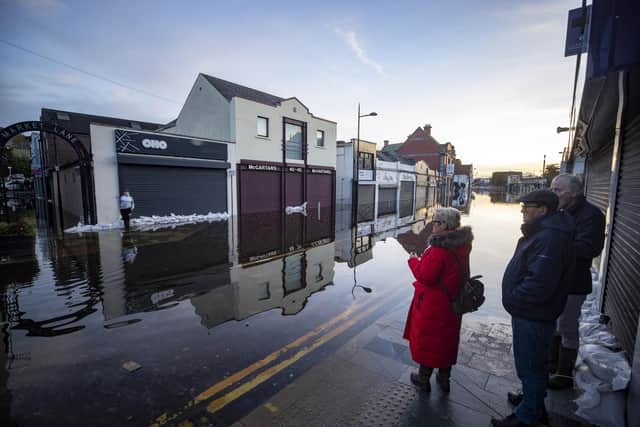 People look at the flooding on Market Street in Downpatrick earlier this week