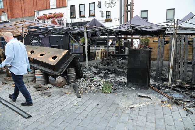 The outside area of a Belfast city centre restaurant has been destroyed in a suspected arson attack