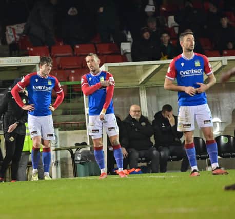 Linfield players dejected on Friday night in the 4-0 loss to Glentoran. (Photo by Pacemaker)