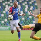 Carrick's Ben Buchanan-Rolleston makes a tackle on Linfield's Kirk Millar during their 3-3 draw at Windsor Park earlier this season. PIC: David Maginnis/Pacemaker Press