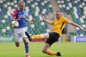 Carrick's Ben Buchanan-Rolleston makes a tackle on Linfield's Kirk Millar during their 3-3 draw at Windsor Park earlier this season. PIC: David Maginnis/Pacemaker Press