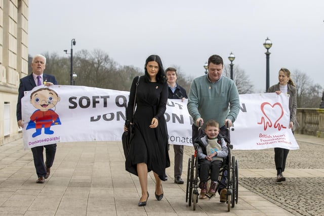 Six-year-old Daithi Mac Gabhann and his parents Mairtin Mac Gabhann  (right) and mother Seph Ni Mheallain  (left) arrive at Parliament Buildings at Stormont, ahead of a recalled sitting of the Assembly focused on a stalled organ donation law.