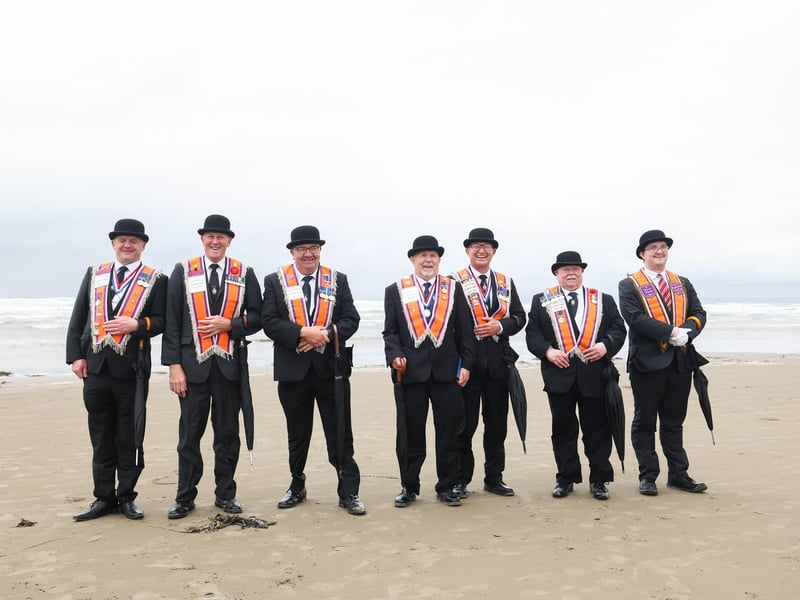 Orange men pictured on the beach