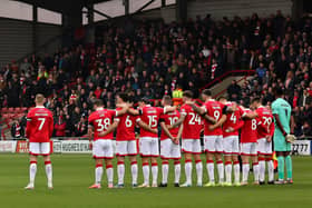 James McClean of Wrexham stood away from his team-mates during the minute’s silence last weekend