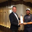 John Blanch (left, Wentworth Golf Club general manager) collects the Winner's Trophy from defending champion Shane Lowry heading into this week's BMW PGA Championship. (Photo by Oisin Keniry/Getty Images)