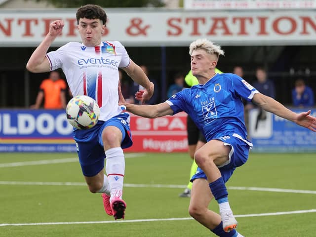 Linfield's Darragh McBrien and Dungannon's Steven Scott contest for the ball during the fixture at Stangmore Park