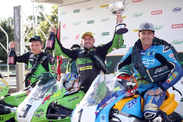 Race winner Rob Hodson celebrates with runner-up Nathan Harrison and David Johnson after the RST Classic Superbike race at the Manx Grand Prix on Monday.