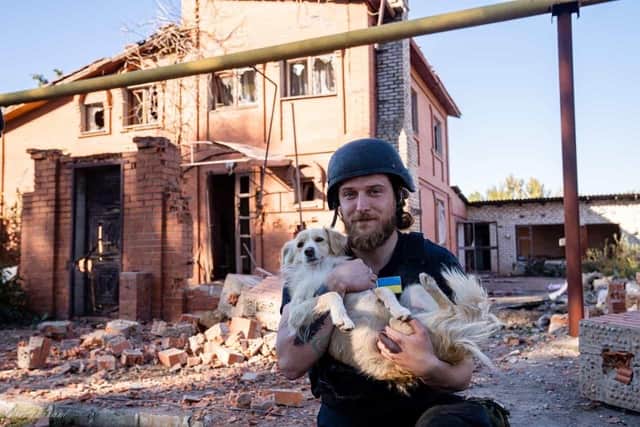 Craig Patterson with a dog he rescued after its owner, a 50-year-old civilian named Olena, was killed following shelling at Zarichne, Donetsk