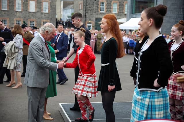 King Charles III shakes hand with a girl as he visits Enniskillen Castle