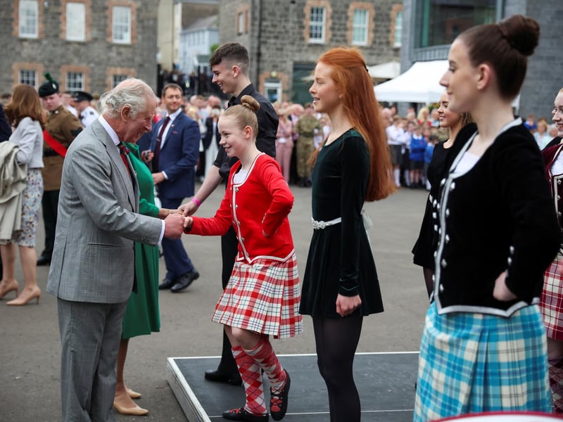 King Charles III shakes hand with a girl as he visits Enniskillen Castle