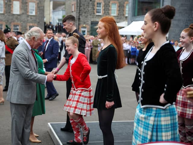 King Charles III shakes hand with a girl as he visits Enniskillen Castle