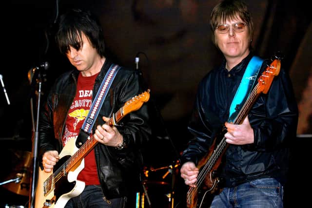 Former members of The Smiths, Andy Rourke (right) and Johnny Marr, on stage during the 'Manchester Versus Cancer' charity concert, held at the Manchester Evening News (M.E.N.) Arena in Manchester. Mr Rourke has died aged 59 after a "lengthy illness with pancreatic cancer", his former bandmate Mr Marr has said.