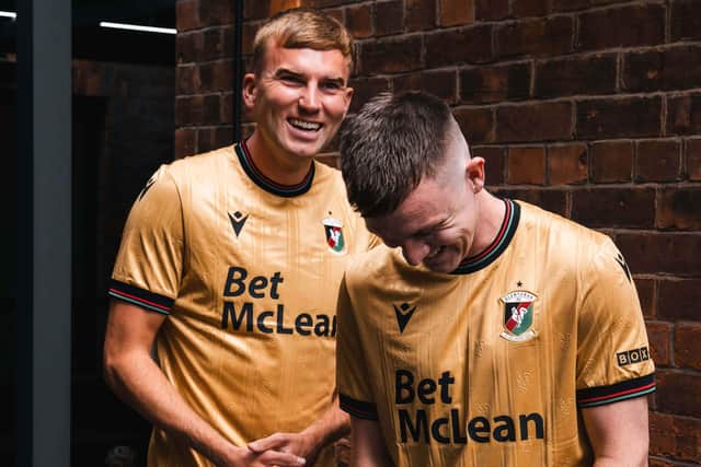 Glentoran defender Daniel Larmour (left) and club vice-captain James Singleton model the club's 'The Gold Standard' away kit for the 2026/27 season. (Photo by Glentoran FC)
