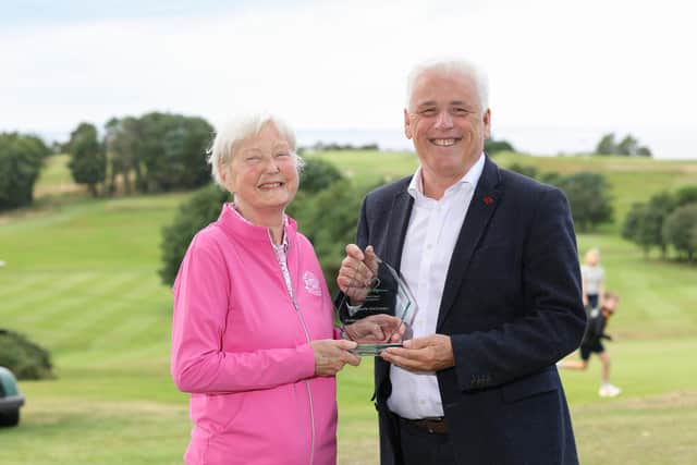Donaghadee woman and heart transplant recipient Valerie McIlveen pictured receiving the British Heart Foundation’s Outstanding Contribution Award for Northern Ireland from head of BHF NI Fearghal McKinney, in recognition of Valerie’s years of fundraising, volunteering and advocacy for people affected by cardiovascular disease