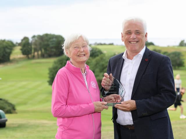 Donaghadee woman and heart transplant recipient Valerie McIlveen pictured receiving the British Heart Foundation’s Outstanding Contribution Award for Northern Ireland from head of BHF NI Fearghal McKinney, in recognition of Valerie’s years of fundraising, volunteering and advocacy for people affected by cardiovascular disease