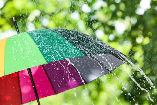 Colourful umbrella outdoors on rainy day