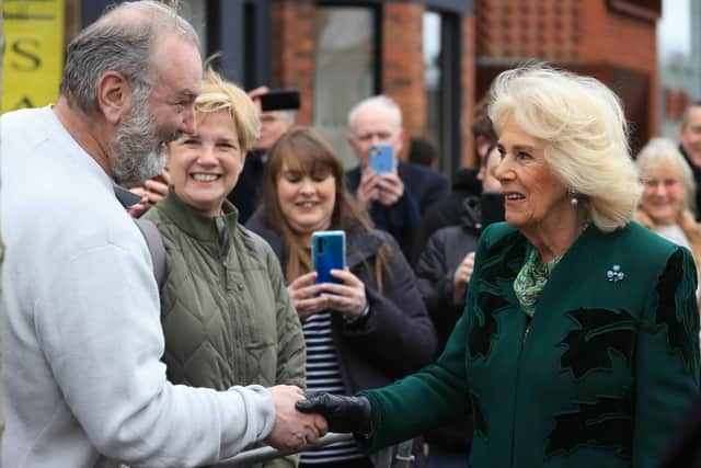 Queen Camilla meets members of the public during a visit to the Lisburn Road in Belfast