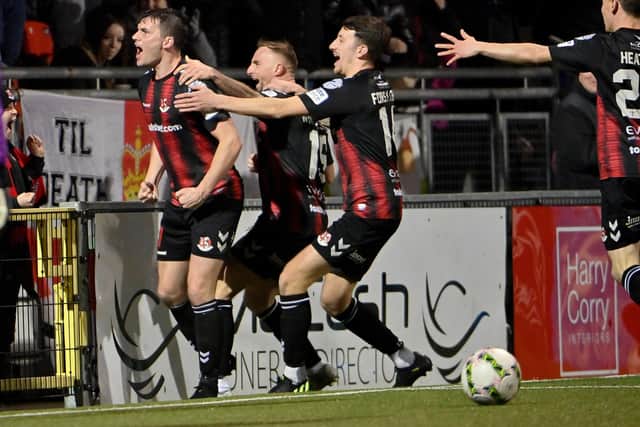 Philip Lowry (left) celebrates scoring for Crusaders against Linfield