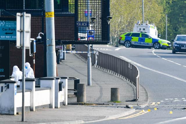 The scene outside Dunmurry Police station on Sunday morning as forensic teams carry out checks.