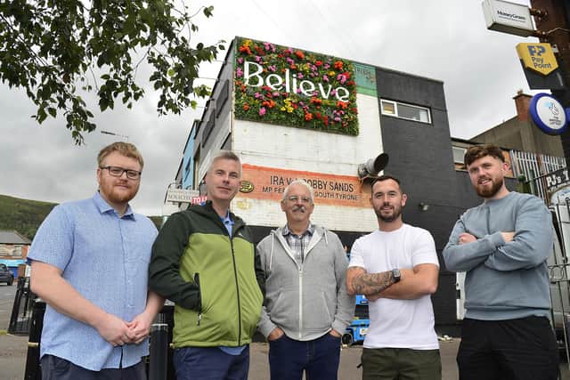 Stuart Lavery (left), Good Relations Officer with the Housing Executive, which funded the replacement of an historical mural, admires the new art work with Steven Corr, Falls Community Council, Tommy Holland, Community Development Worker, and Micheal Donnelly and Cónall O’Corra, Upper Springfield Development Trust