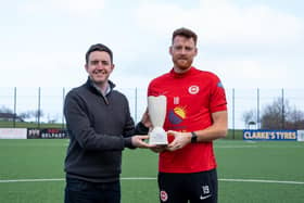 NIFWA Chairman Michael Clarke gives Larne's Cian Bolger with the Dream Spanish Homes Player of the Month trophy for February