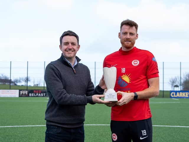 NIFWA Chairman Michael Clarke gives Larne's Cian Bolger with the Dream Spanish Homes Player of the Month trophy for February