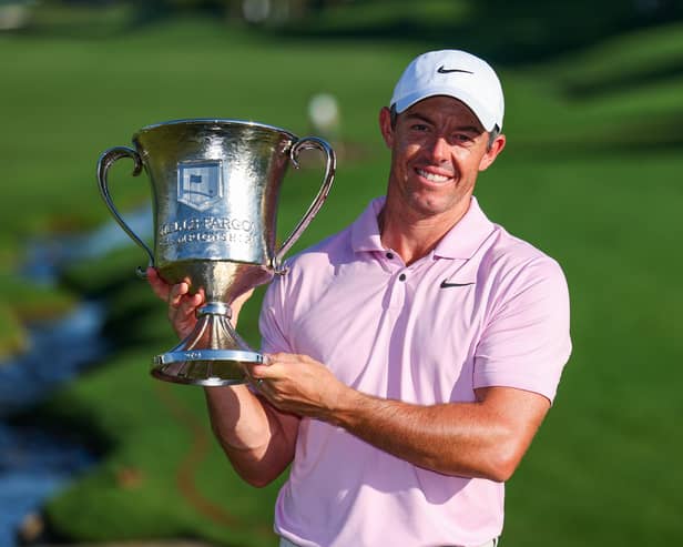 Northern Ireland's Rory McIlroy celebrates with the trophy after winning a record-extending fourth Wells Fargo Championship. (Photo by Andrew Redington/Getty Images)