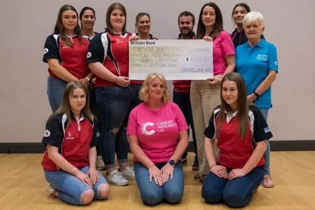 Rathfriland YFC committee members present a cheque to Cancer Research in memory of Mrs Mae Ingram. Picture: Rathfriland YFC