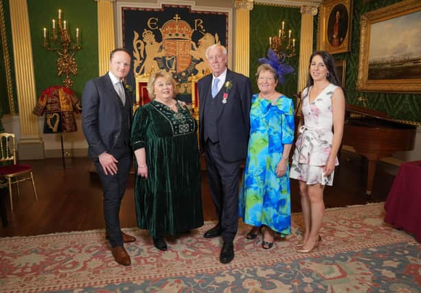 Robin Mercer BEM is pictured with Lord Lieutenant Dame Fionnuala Jay-O'Boyle DBE, at a ceremony in Hillsborough Castle, where he was presented with the British Empire Medal. He is joined by his wife Edith, son Alan and his wife Ciara. Credit: Aaron McCracken