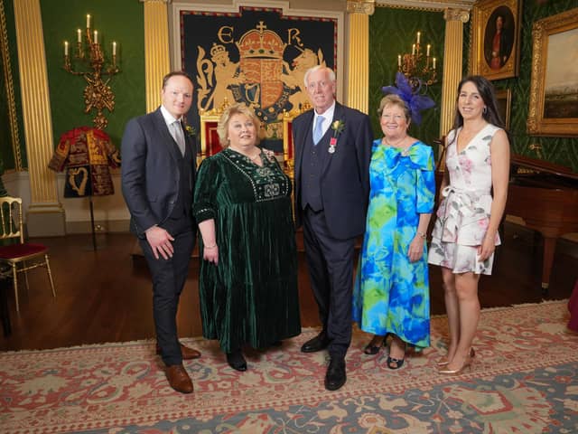 Robin Mercer BEM is pictured with Lord Lieutenant Dame Fionnuala Jay-O'Boyle DBE, at a ceremony in Hillsborough Castle, where he was presented with the British Empire Medal. He is joined by his wife Edith, son Alan and his wife Ciara. Credit: Aaron McCracken