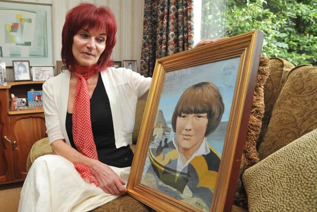 Mary Hornsey, mother of Paul Maxwell, with a portrait of him (2009)