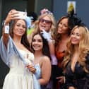 Racegoers take a selfie during the 2024 Randox Grand National Festival at Aintree Racecourse, Liverpool. (Photo by Mike Egerton/PA Wire)