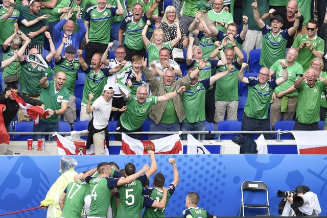 Northern Ireland's players celebrate after scoring during the Euro 2016 group C football match between Ukraine and Northern Ireland at the Parc Olympique Lyonnais stadium in Décines-Charpieu near Lyon on June 16, 2016.