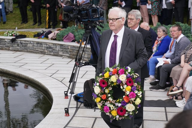 Michael Gallagher who lost his son Aiden in the bombing, prepares to lay a wreath during a service to mark the 25th anniversary of the bombing that devastated Omagh in 1998