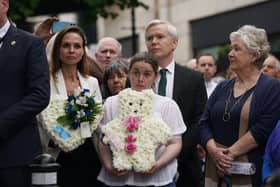 Relatives of victims attend a wreath-laying ceremony at the Memorial to the victims of the Dublin and Monaghan bombings on Talbot Street in Dublin, to mark the 50th anniversary of the bombings