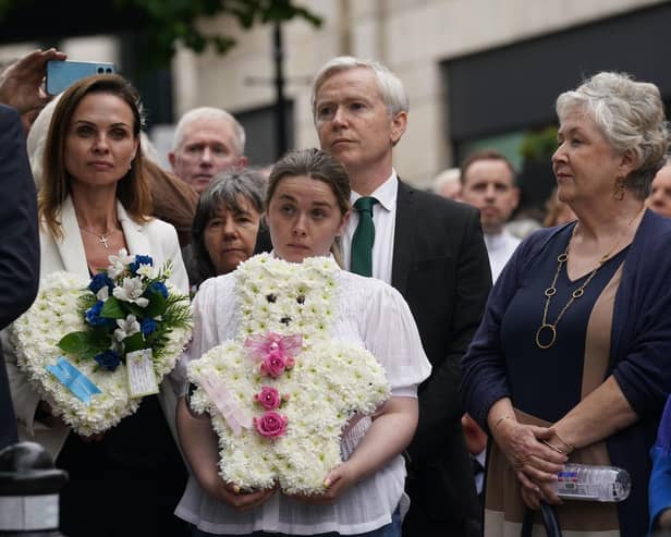 Relatives of victims attend a wreath-laying ceremony at the Memorial to the victims of the Dublin and Monaghan bombings on Talbot Street in Dublin, to mark the 50th anniversary of the bombings