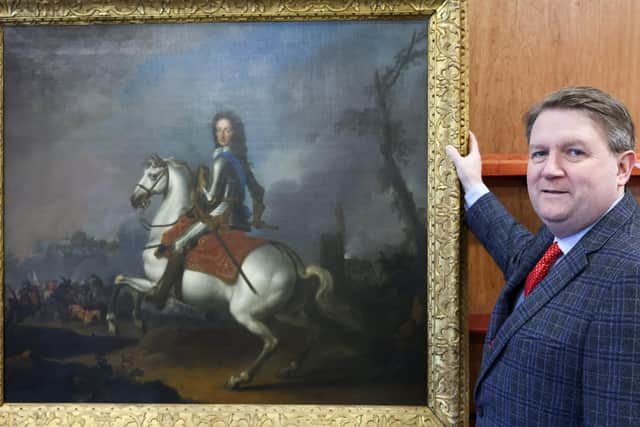 A 17th Century painting of King William III in action at the Battle of the Boyne has sold for £21,500 at an auction house in east Belfast. Pictured is Karl Bennett with the King William III portrait